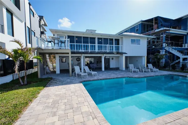 a view of a house with backyard porch and sitting area