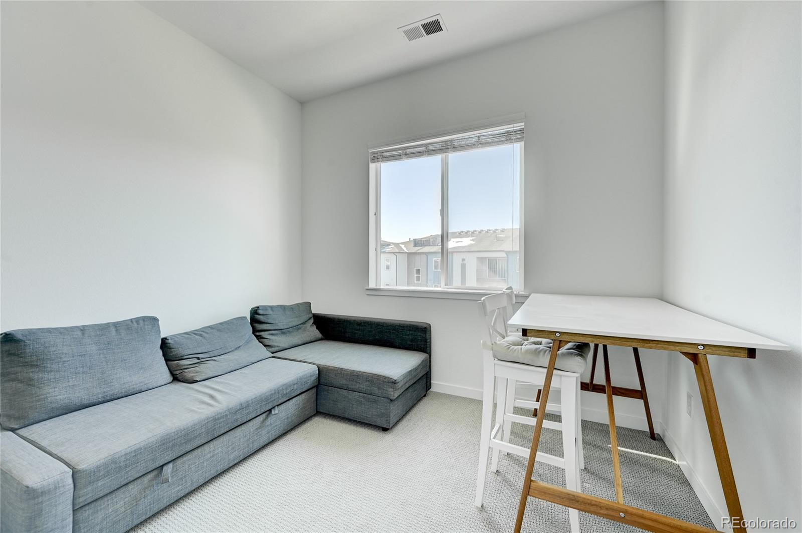 9287 Twenty Mile Road, Unit 405 Parker, CO 80134 - Photo 19 of 31 a living room with furniture and a window