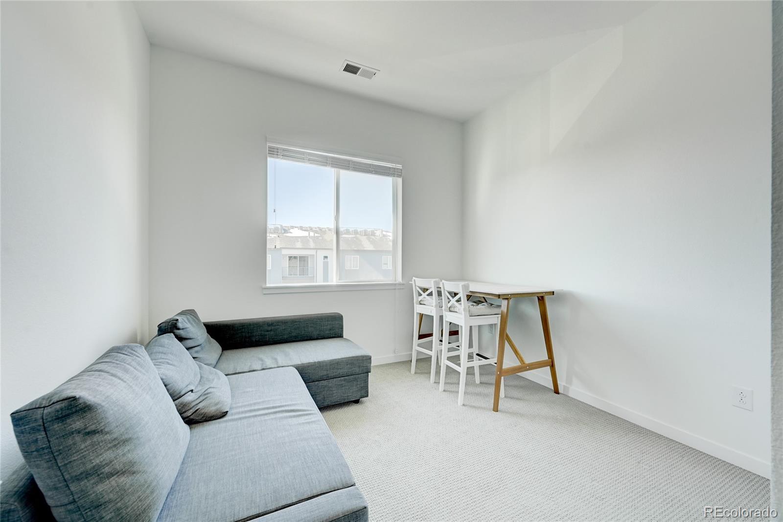 9287 Twenty Mile Road, Unit 405 Parker, CO 80134 - Photo 19 of 28 a living room with furniture and a window