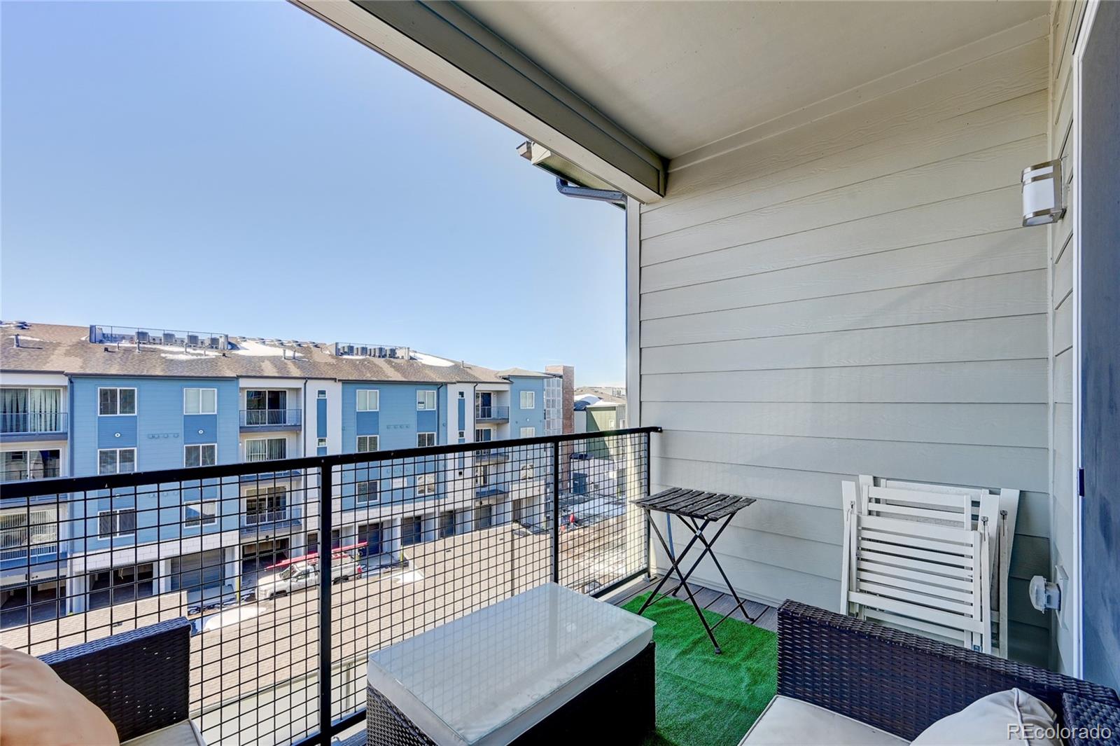 9287 Twenty Mile Road, Unit 405 Parker, CO 80134 - Photo 24 of 31 a balcony with a city view