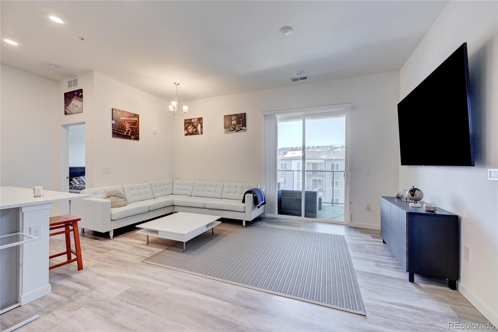9287 Twenty Mile Road, Unit 405 Parker, CO 80134 - Photo 7 of 28 a living room with furniture and a flat screen tv