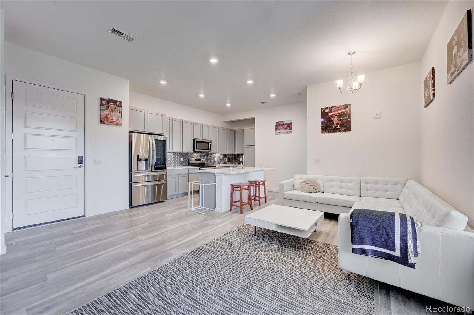 9287 Twenty Mile Road, Unit 405 Parker, CO 80134 - Photo 8 of 28 a living room with furniture and kitchen view