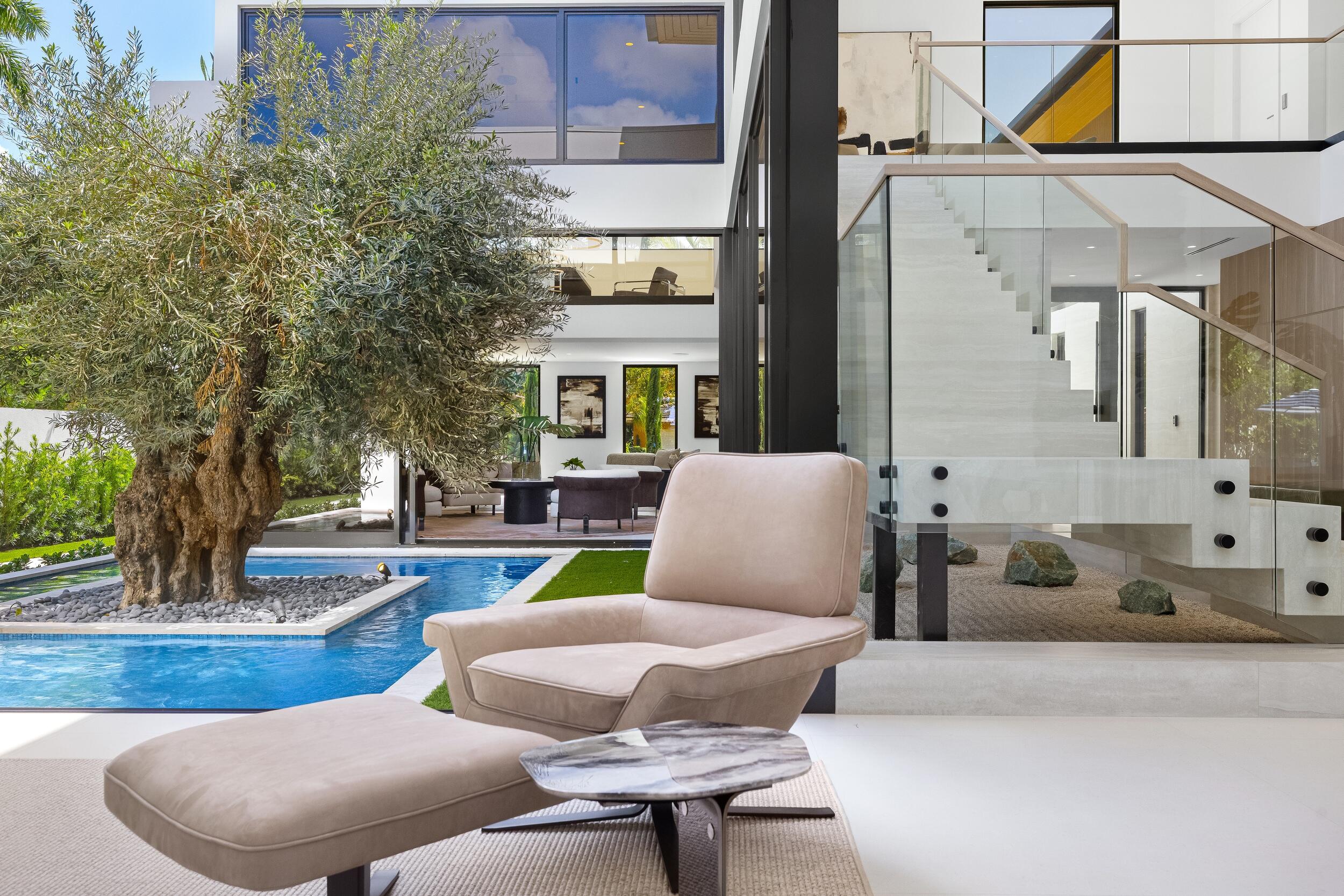 1351 Cocoanut Road Boca Raton, FL 33432 - Photo 18 of 101 a view of a patio with couches chairs and a potted plant