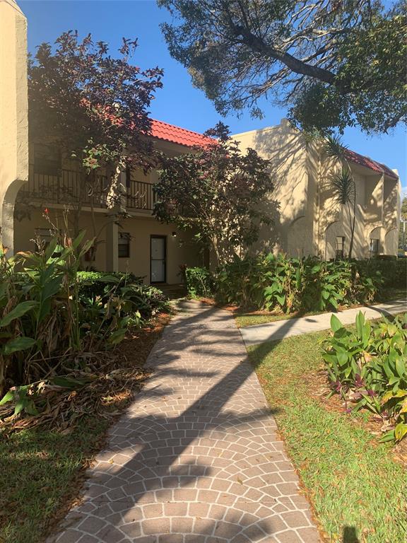 2050 Oleander Boulevard, Unit 4 104 Fort Pierce, FL 34950 - Photo 1 of 4 a view of a house with a yard