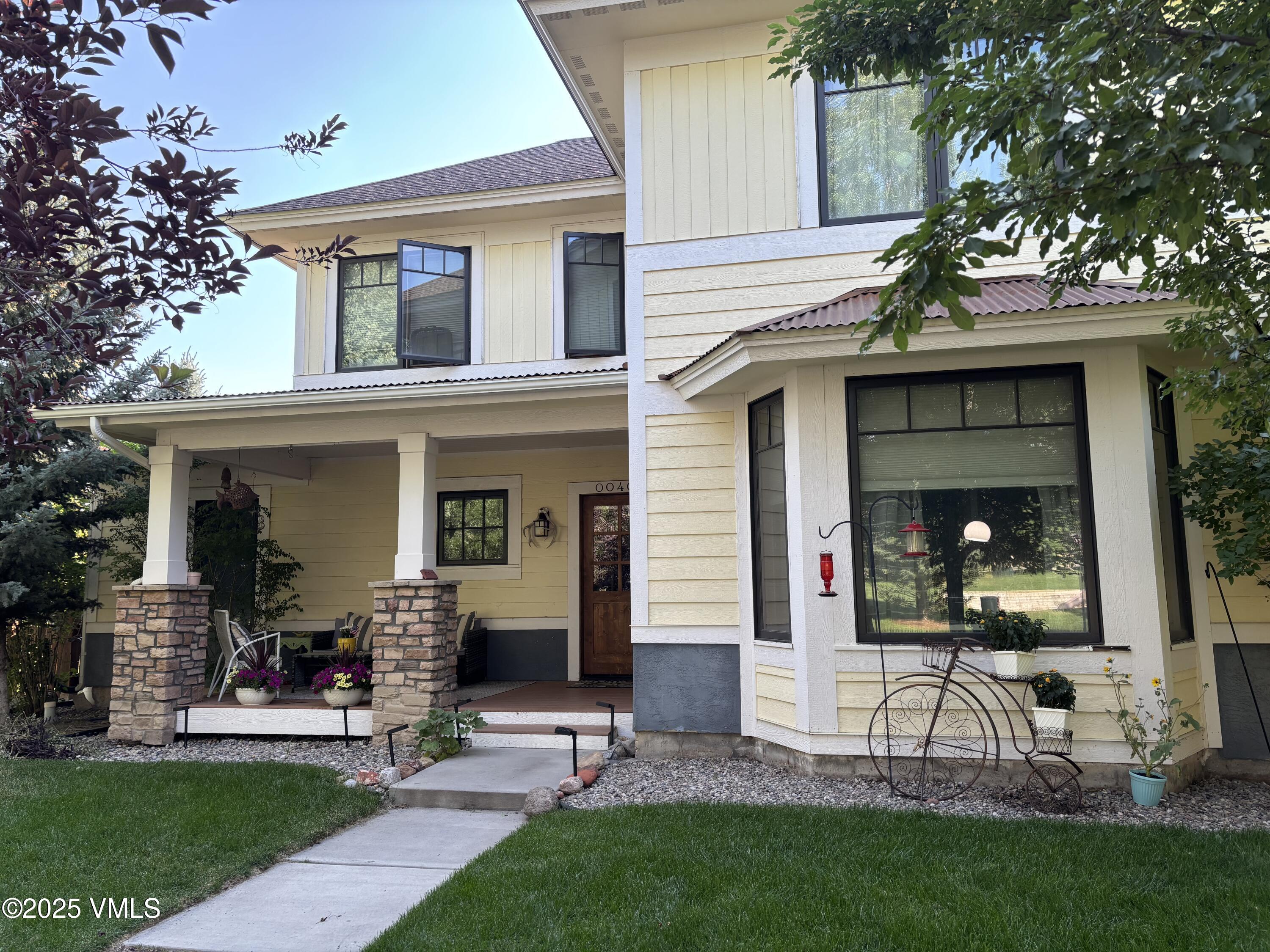 a view of house with a yard and table and chair