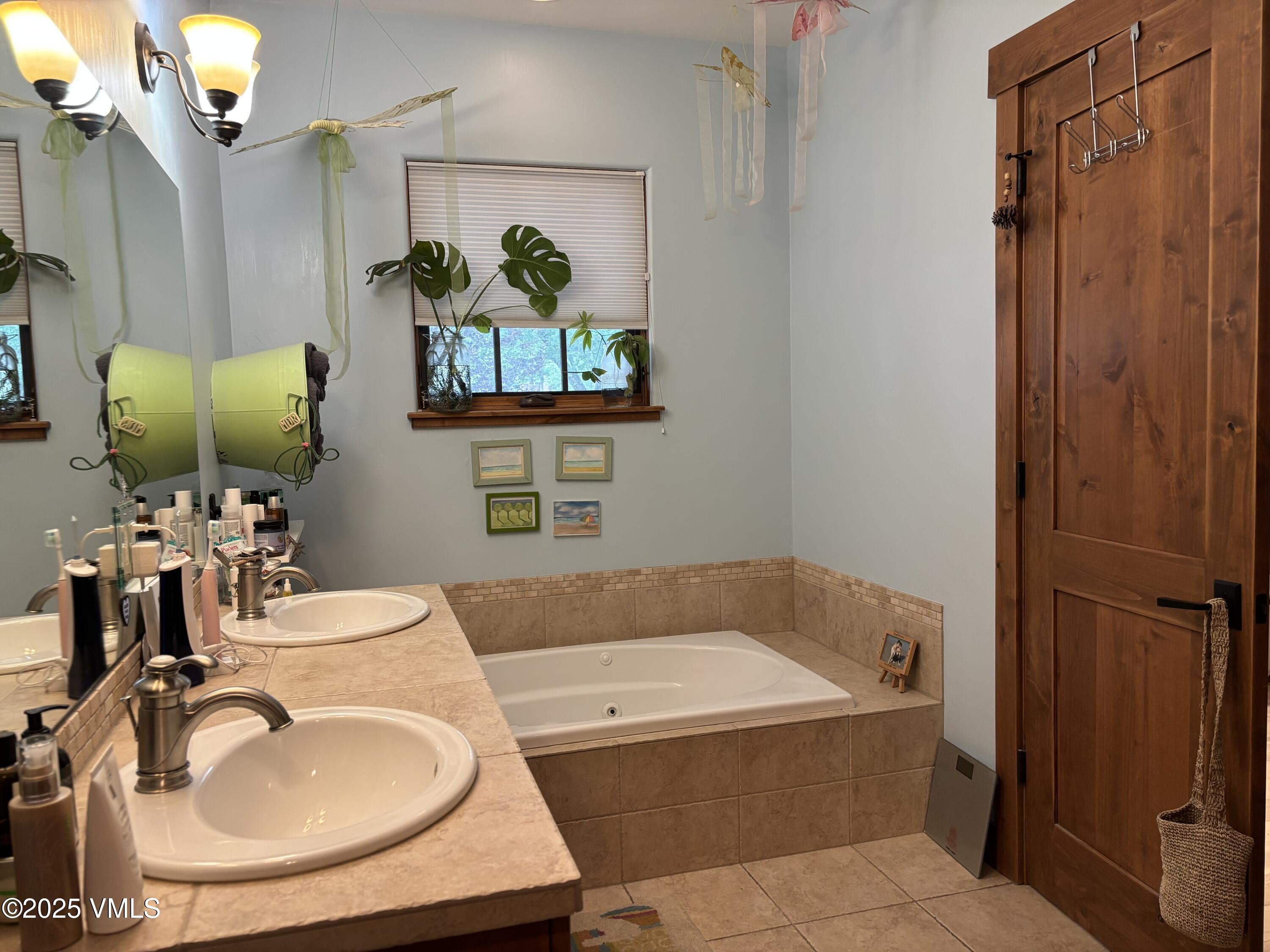 40 Bunker Way Eagle, CO 81631 - Photo 13 of 18 a bathroom with a tub sink and mirror