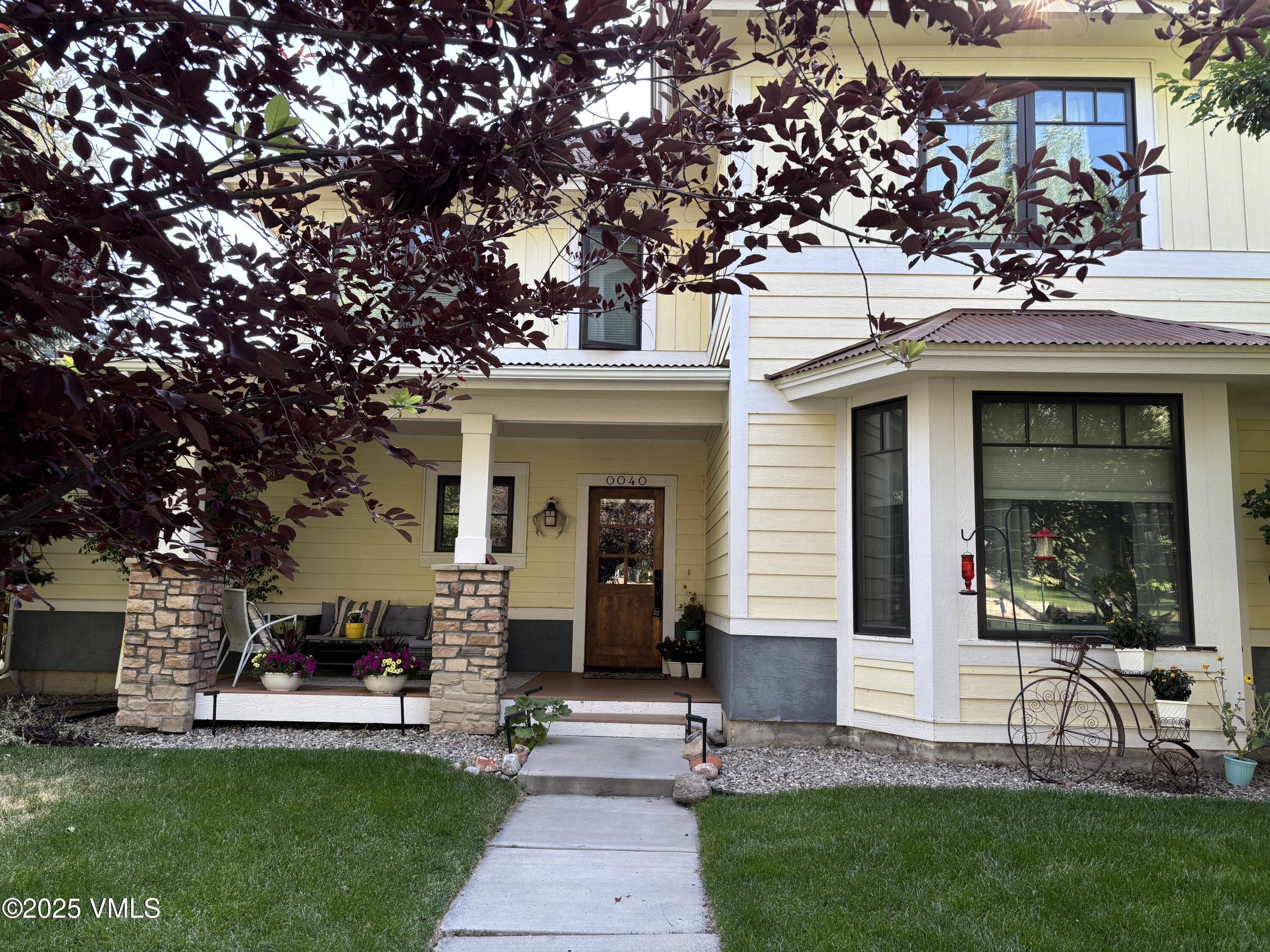 40 Bunker Way Eagle, CO 81631 - Photo 2 of 18 a front view of a house with a garden and plants