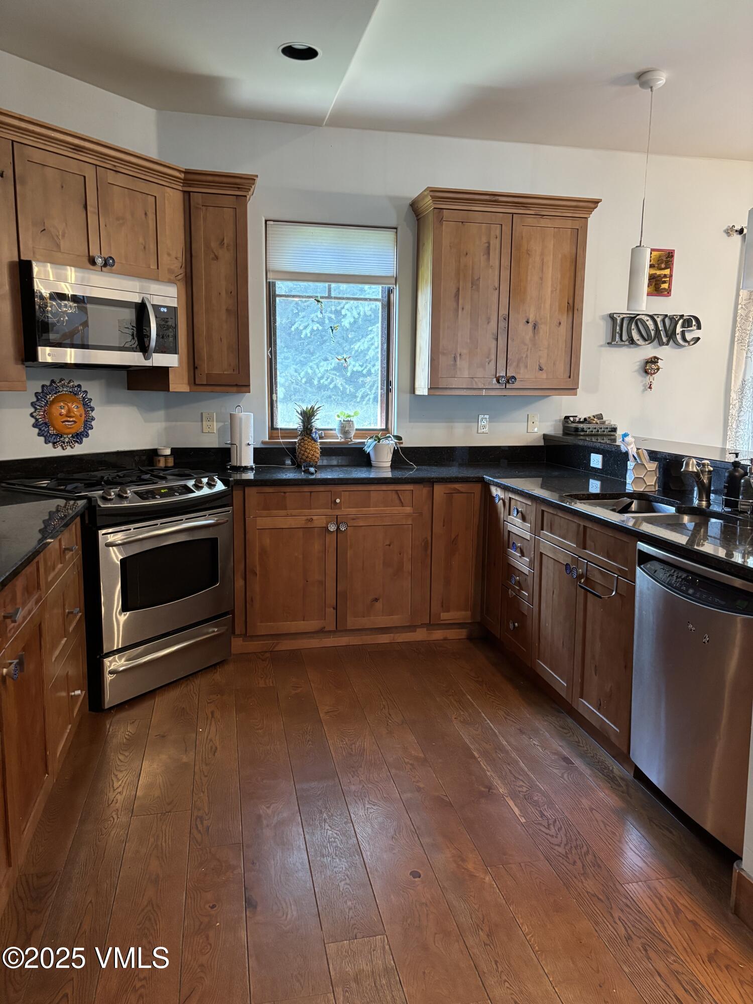 40 Bunker Way Eagle, CO 81631 - Photo 5 of 18 a kitchen with stainless steel appliances granite countertop a stove a sink and a microwave