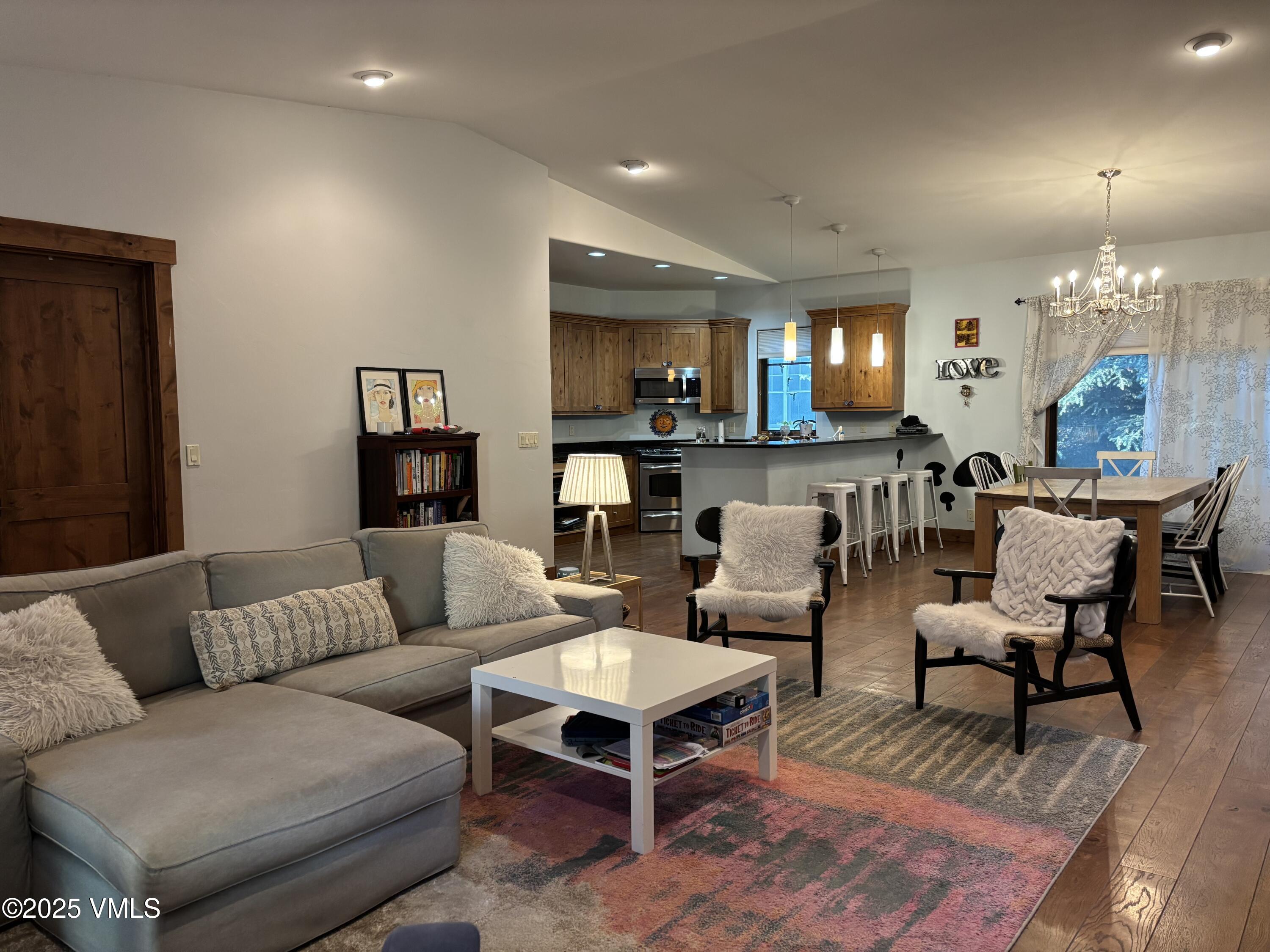 40 Bunker Way Eagle, CO 81631 - Photo 9 of 18 a living room with furniture a lamp and a chandelier