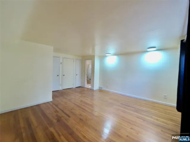 a view of an empty room and wooden floor