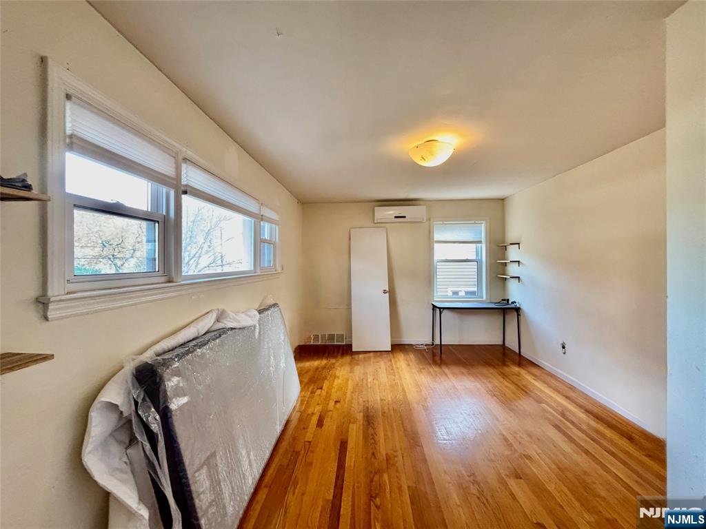 62 Howland Avenue Teaneck, NJ 07666 - Photo 7 of 14 a view of a livingroom with wooden floor and a window