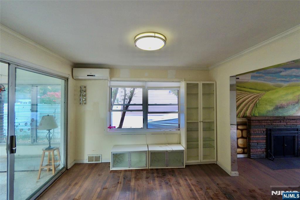 62 Howland Avenue Teaneck, NJ 07666 - Photo 8 of 14 a room with wooden floor and a fireplace