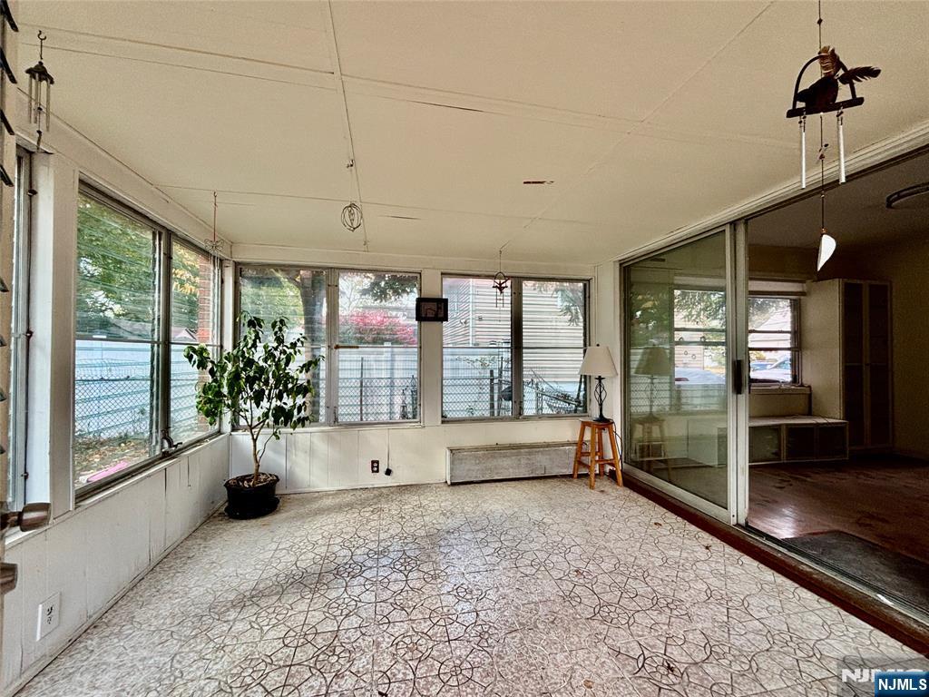 62 Howland Avenue Teaneck, NJ 07666 - Photo 9 of 14 a view of entryway with a floor to ceiling window and potted plants
