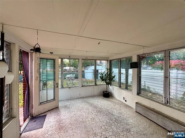 a view of living room with furniture and large windows