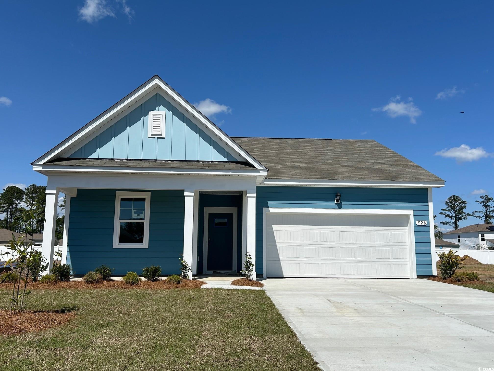 528 Duvall Street Longs, SC 29568 - Photo 1 of 14 View of front facade with a garage, driveway, boar