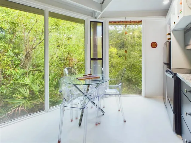 a living room view with a fireplace and a large window
