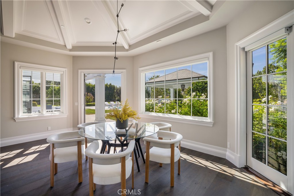 24200 Hidden Ridge Road Hidden Hills, CA 91302 - Photo 14 of 61 a dining room with furniture a chandelier and wooden floor