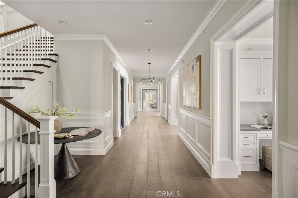 24200 Hidden Ridge Road Hidden Hills, CA 91302 - Photo 20 of 61 a view of a hallway with wooden floor and staircase