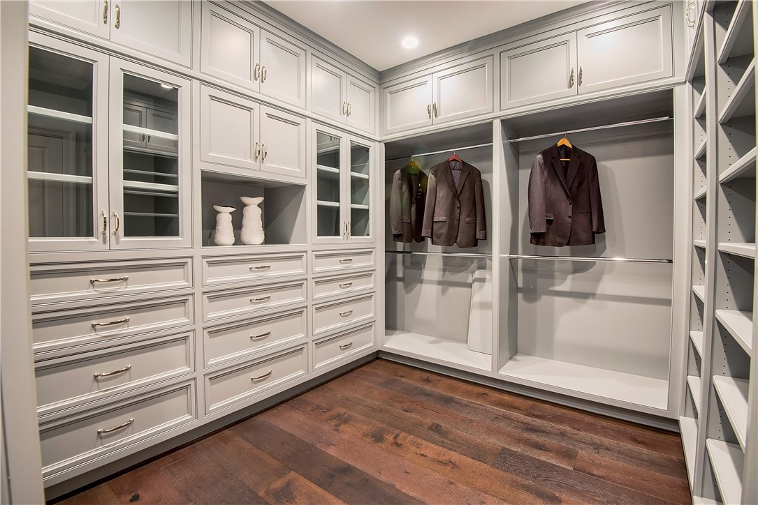 24200 Hidden Ridge Road Hidden Hills, CA 91302 - Photo 28 of 61 a view of walk in closet with empty racks