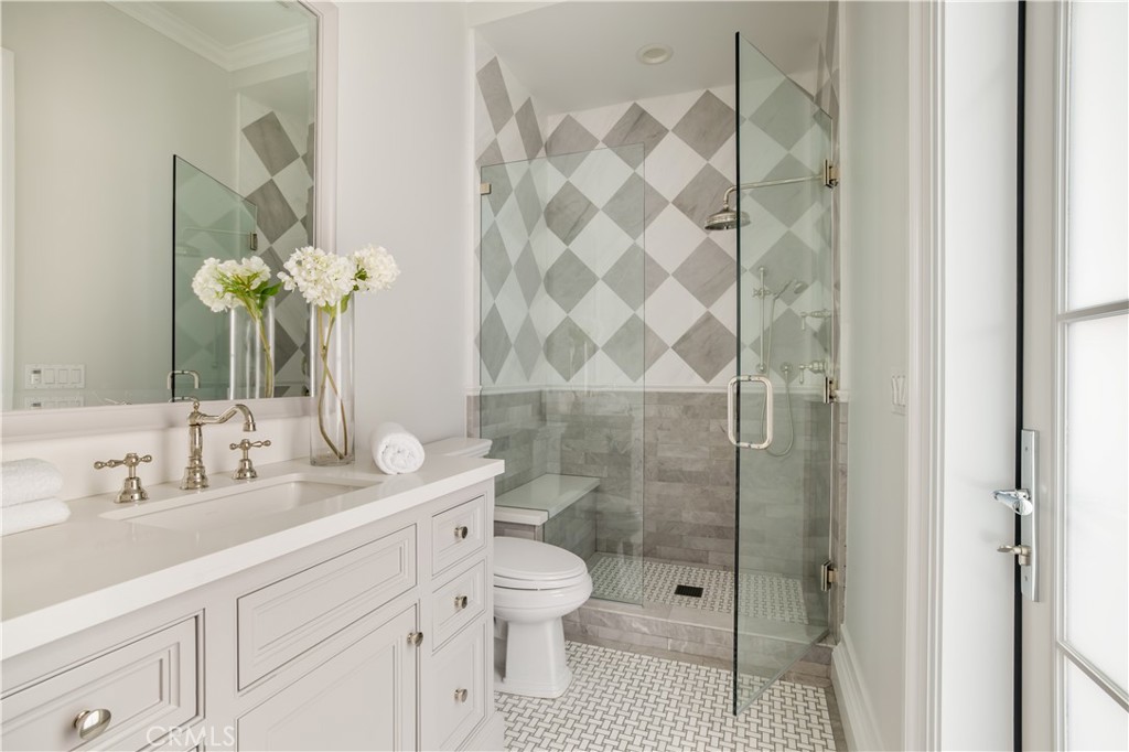 24200 Hidden Ridge Road Hidden Hills, CA 91302 - Photo 34 of 61 a bathroom with a sink a toilet and shower