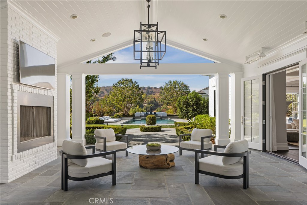 24200 Hidden Ridge Road Hidden Hills, CA 91302 - Photo 48 of 61 a living room with furniture and a chandelier