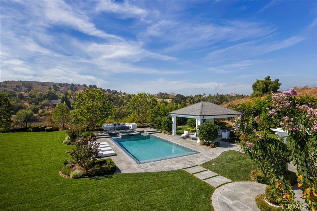 24200 Hidden Ridge Road Hidden Hills, CA 91302 - Photo 55 of 61 a view of a house with a yard