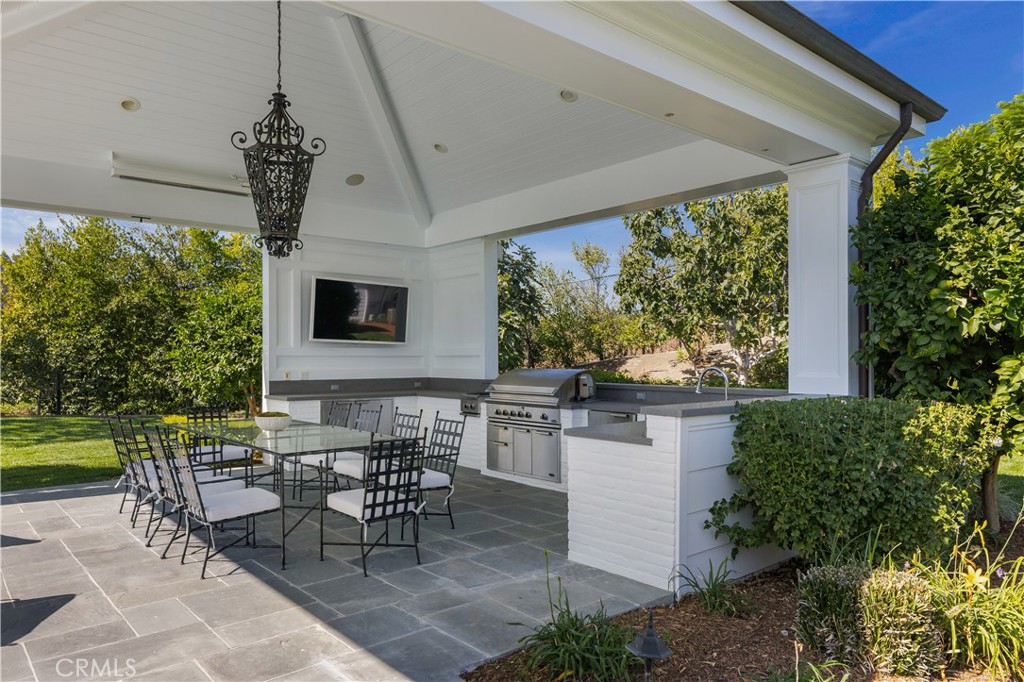 24200 Hidden Ridge Road Hidden Hills, CA 91302 - Photo 58 of 61 a outdoor dining space with furniture