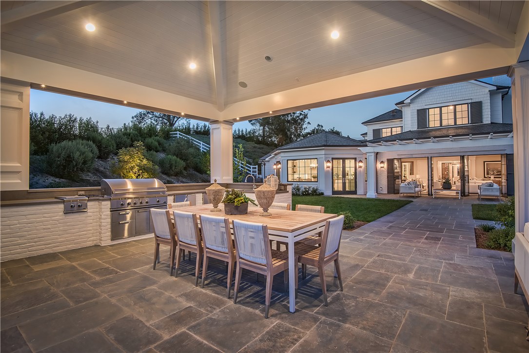 24200 Hidden Ridge Road Hidden Hills, CA 91302 - Photo 59 of 61 a view of a patio with a dining table and chairs