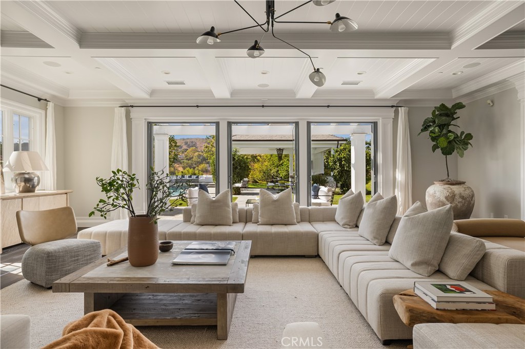 24200 Hidden Ridge Road Hidden Hills, CA 91302 - Photo 6 of 61 a living room with furniture and floor to ceiling windows