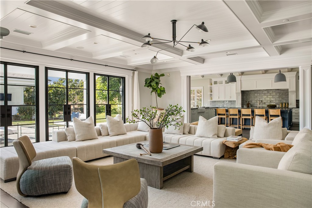 24200 Hidden Ridge Road Hidden Hills, CA 91302 - Photo 9 of 61 a living room with furniture large windows and ceiling fan