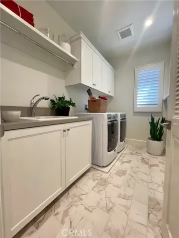a room with a sink and cabinets