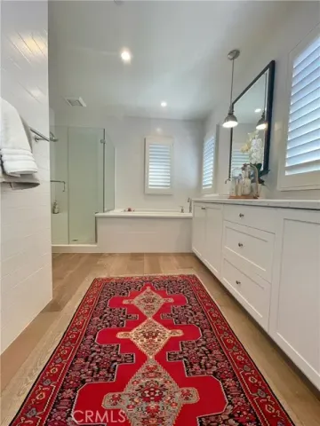 a spacious bedroom with a bed and a mirror