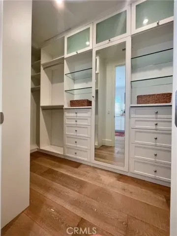 a view of walk in closet with empty racks
