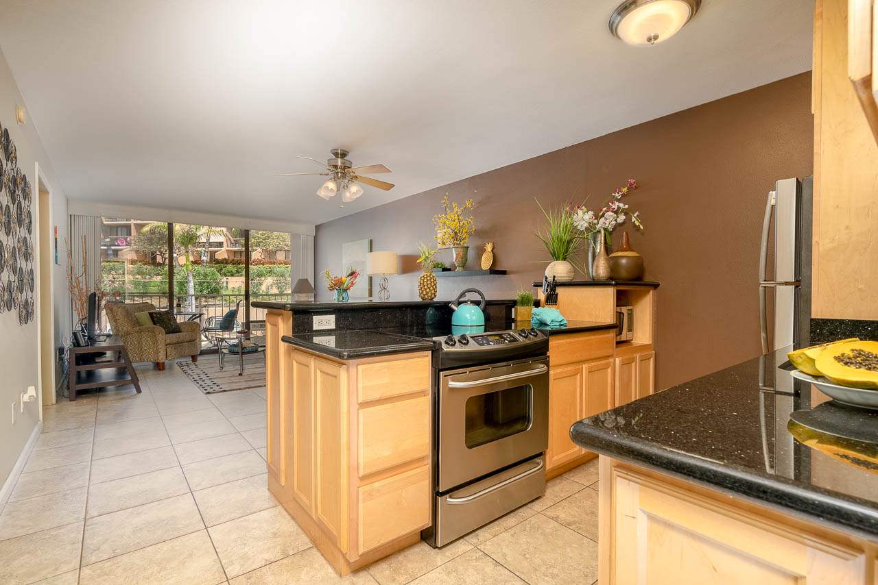 a kitchen with stainless steel appliances granite countertop a stove and a sink