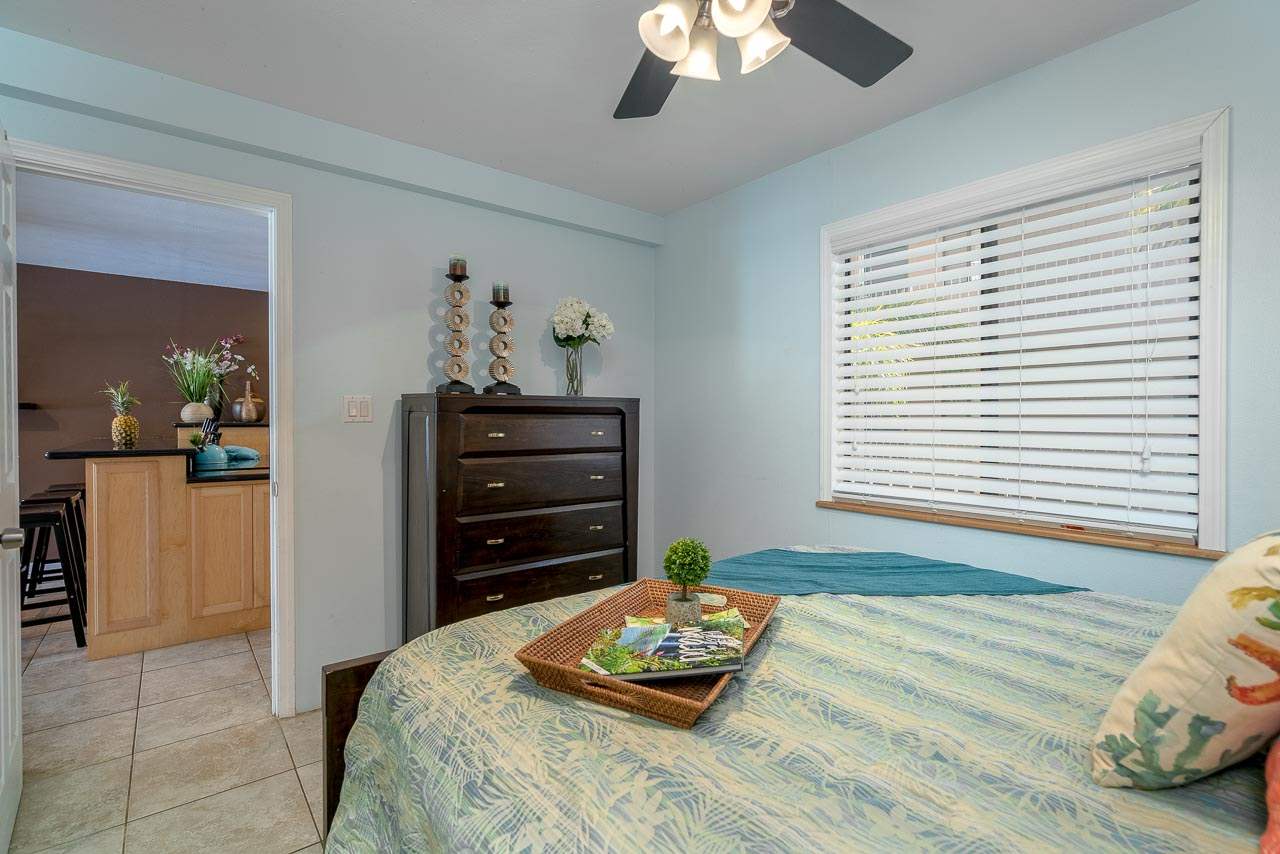 2219 South Kihei Road, Unit B216 Kihei, HI 96753 - Photo 14 of 29 a bedroom with a bed and a chandelier