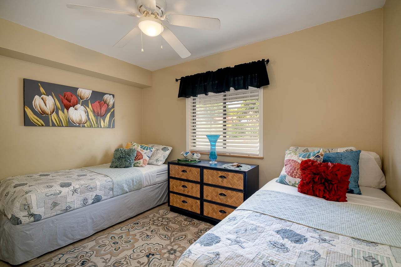 2219 South Kihei Road, Unit B216 Kihei, HI 96753 - Photo 17 of 29 a bedroom with a bed and a chandelier