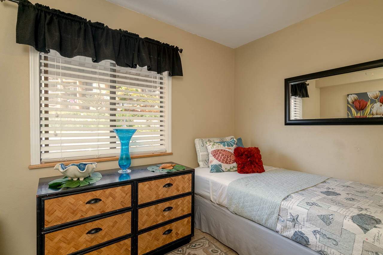 2219 South Kihei Road, Unit B216 Kihei, HI 96753 - Photo 18 of 29 a bedroom with a bed and a window