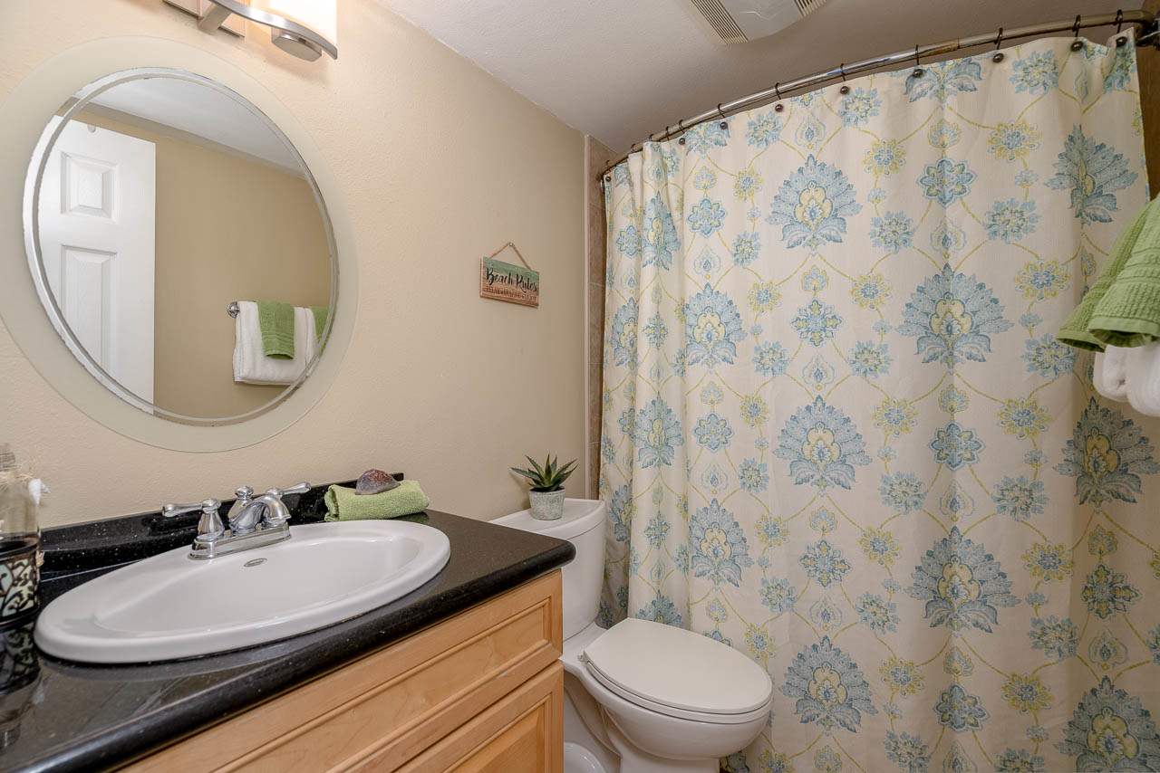 2219 South Kihei Road, Unit B216 Kihei, HI 96753 - Photo 19 of 29 a bathroom with a granite countertop toilet a sink and a mirror