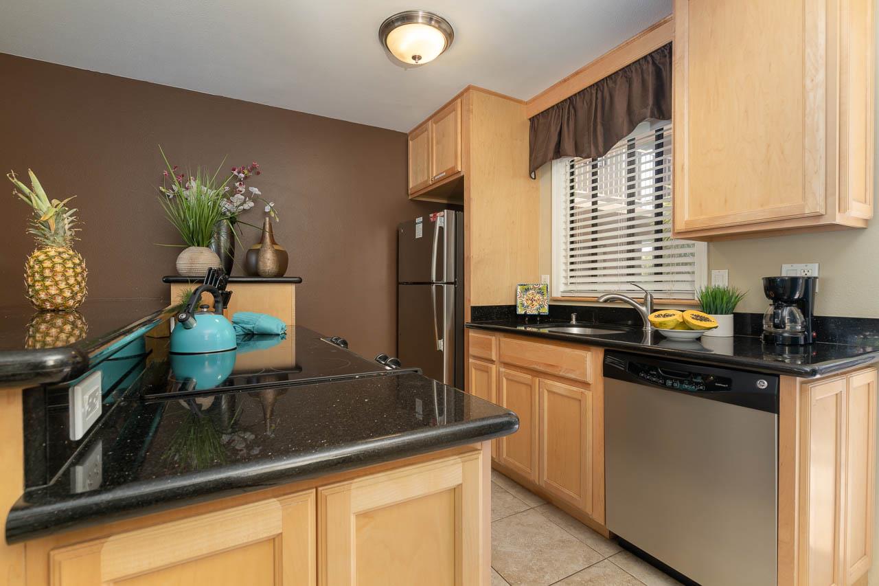2219 South Kihei Road, Unit B216 Kihei, HI 96753 - Photo 3 of 29 a kitchen with stainless steel appliances granite countertop sink stove top oven and cabinets