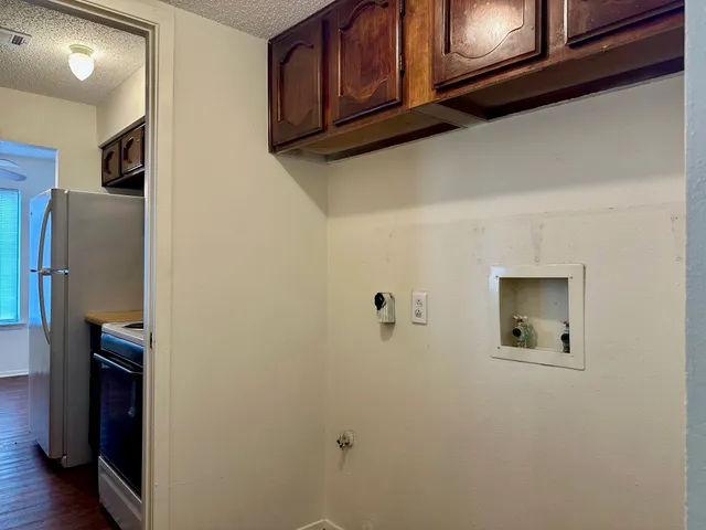 a room with cabinets and a refrigerator