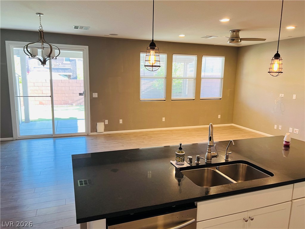 9325 Keystone Ridge Avenue Las Vegas, NV 89148 - Photo 4 of 17 A well-appointed kitchen island with sleek counters anchors this naturally illuminated open-concept living space.