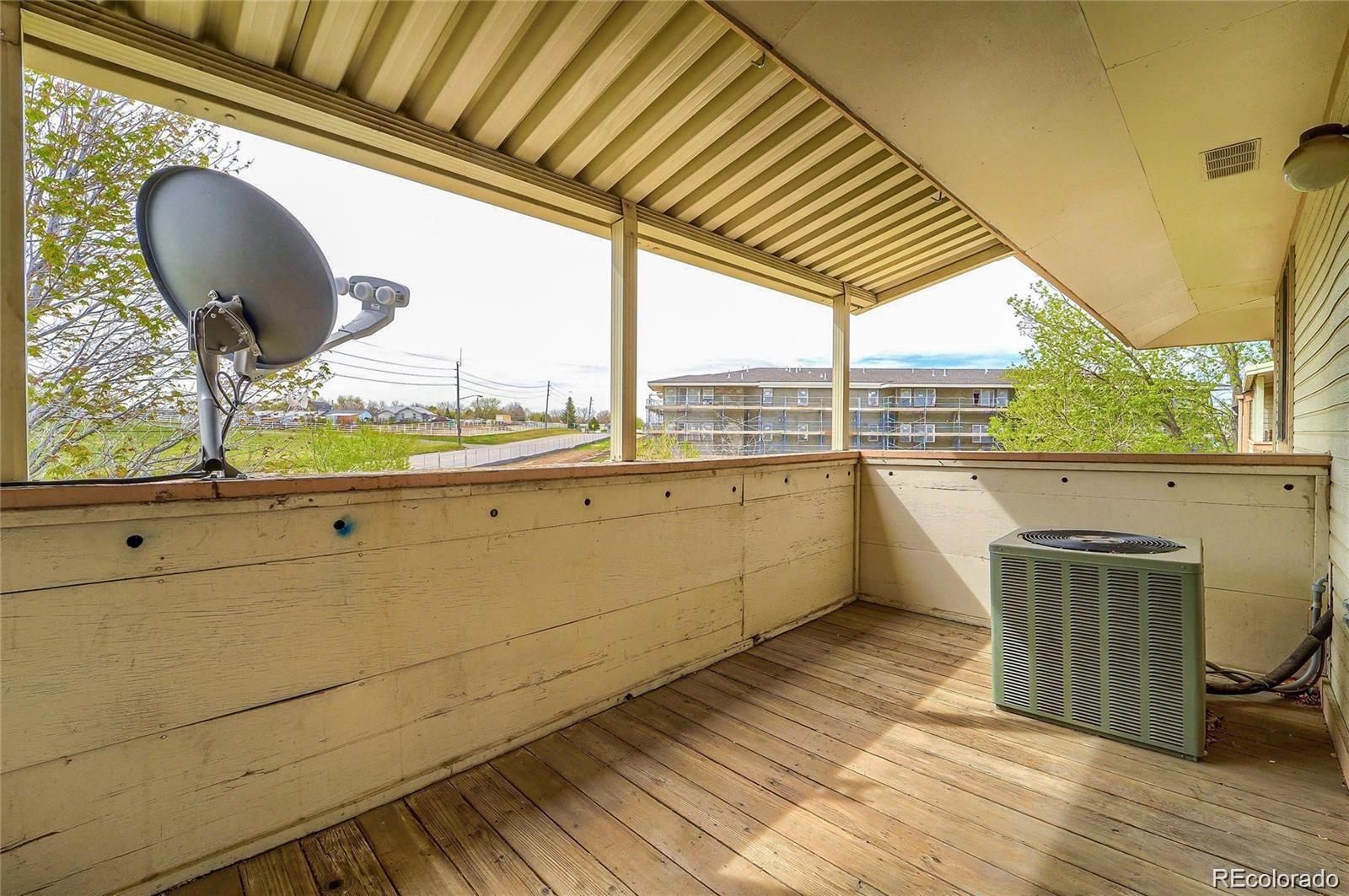 2231 Sable Boulevard, Unit 909 Aurora, CO 80011 - Photo 14 of 16 a view of a bathroom with a sink and wooden floor