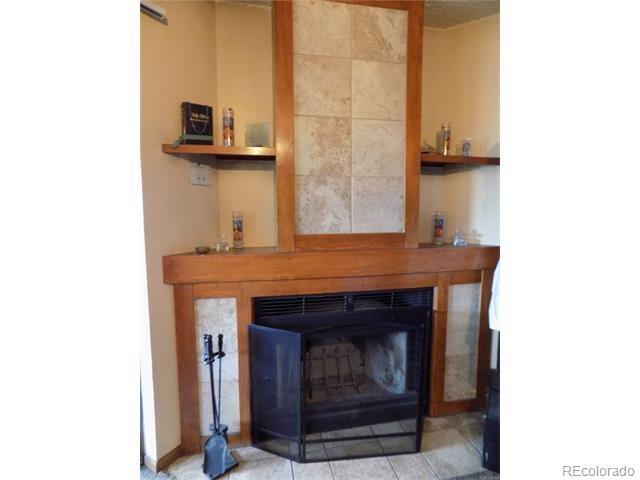 2231 Sable Boulevard, Unit 909 Aurora, CO 80011 - Photo 3 of 16 a living room with a fireplace