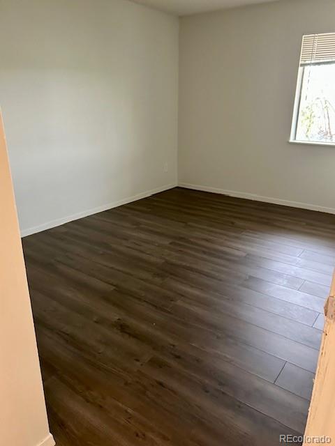 2231 Sable Boulevard, Unit 909 Aurora, CO 80011 - Photo 5 of 16 an empty room with wooden floor and windows