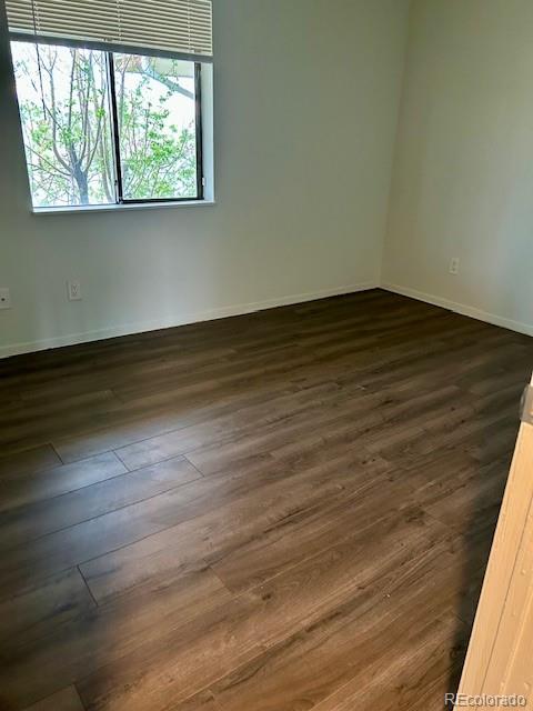 2231 Sable Boulevard, Unit 909 Aurora, CO 80011 - Photo 6 of 16 a view of an empty room with wooden floor and a window