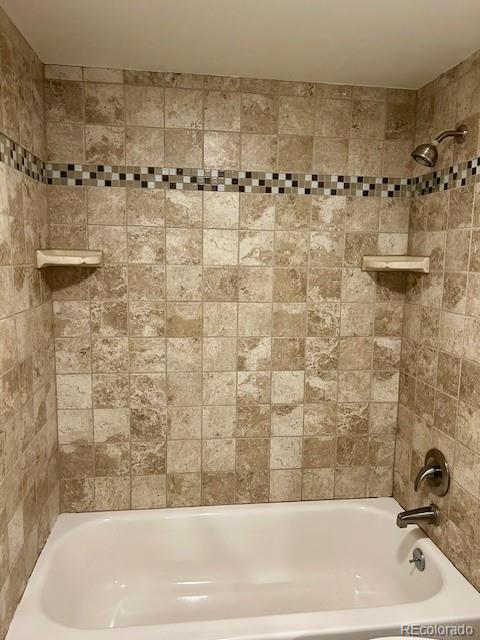 2231 Sable Boulevard, Unit 909 Aurora, CO 80011 - Photo 8 of 16 a bathroom with a bathtub and shower