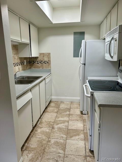 2231 Sable Boulevard, Unit 909 Aurora, CO 80011 - Photo 10 of 16 a kitchen with stainless steel appliances granite countertop a sink and a refrigerator