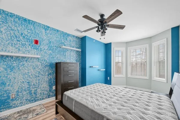 a bedroom with a bed and a chandelier