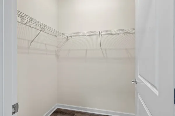 a spacious bathroom with a granite countertop sink toilet mirror and a shower