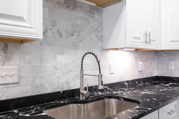 a kitchen with kitchen island a dining table and chairs